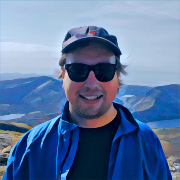 Jan on a hiking trail Jan with mountains and lakes in the background in Snowdonia